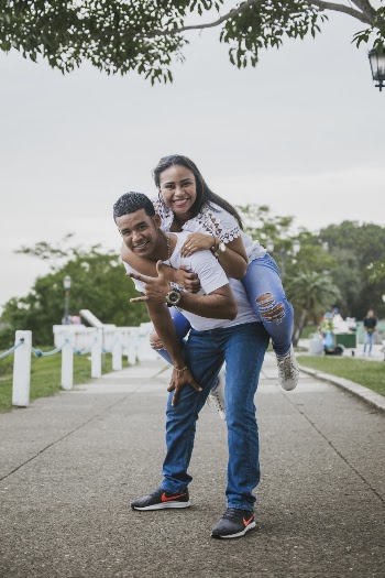 Photo of Man Giving Woman a Piggyback Ride