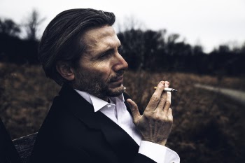 Photo of Man Holding a Cigarette