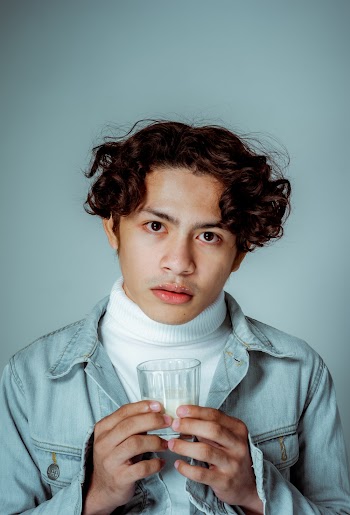 Photo of Man Holding a Glass