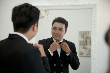 Photo Of Man Holding Black Bowtie