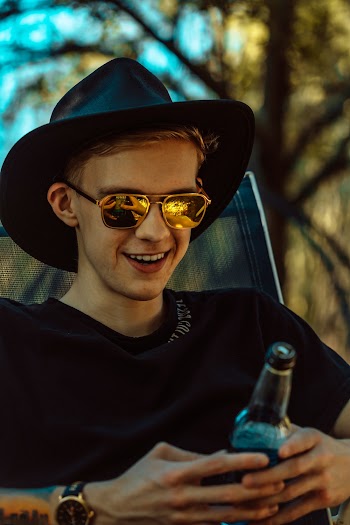 Photo Of Man Holding Bottle 