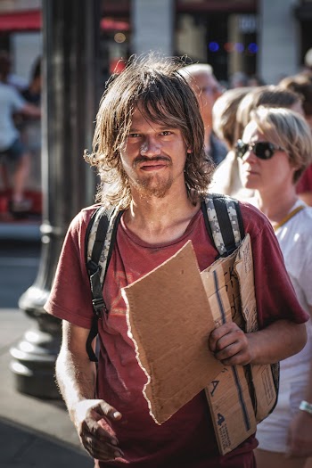 Photo of Man Holding Cardboard