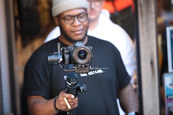 Photo of Man Holding Digital Camera