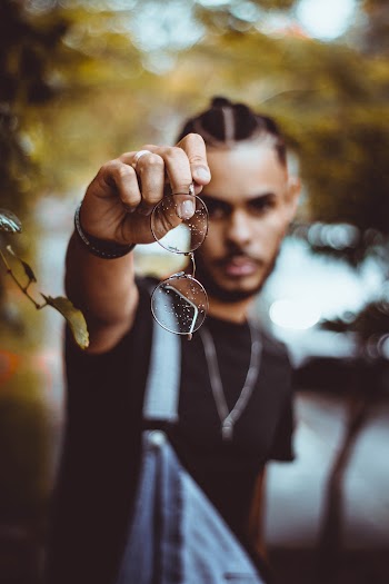 Photo of Man Holding Eyglasses