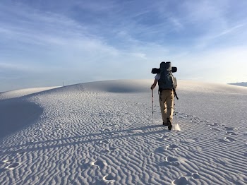 Photo of Man Holding Hiking Poles on Snow Field