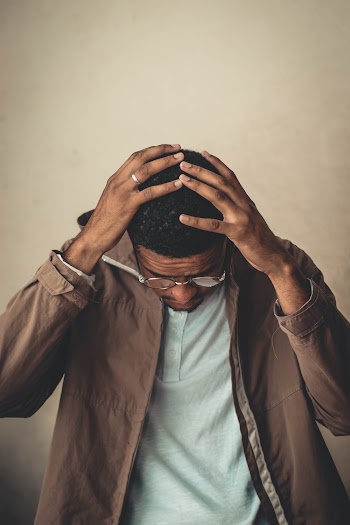 Photo of Man Holding His Head