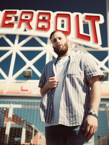 Photo Of Man Holding His Polo