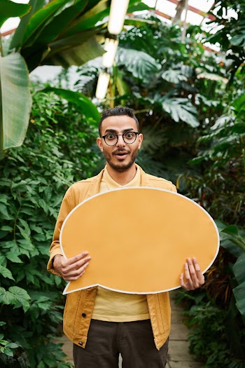 Photo Of Man Holding Signage