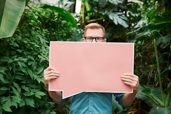 Photo Of Man Holding Signage