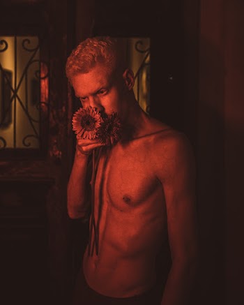 Photo Of Man Holding Sunflowers