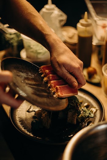 Photo Of Man Holding Sushi 
