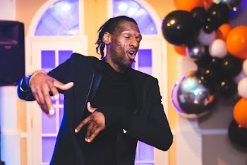 Photo of Man in Black Suit Jacket With His Eyes Closed Dancing 