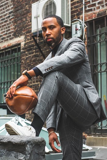 Photo of Man in Formal Wear Holding Football