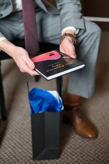 Photo of Man in Gray Formal Suit Holding Black Book