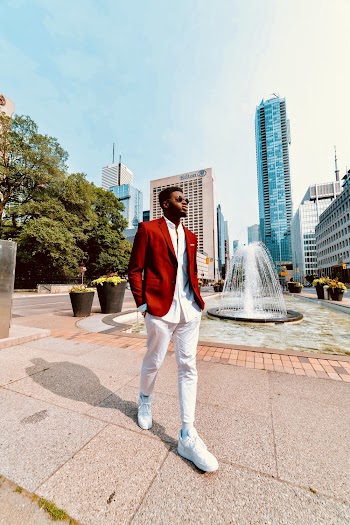Photo of Man in Red Blazer and White Pants Walking