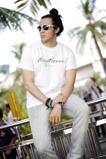 Photo of Man in White T-shirt and Faded Blue Denim Jeans Sitting on Hand Rail Posing