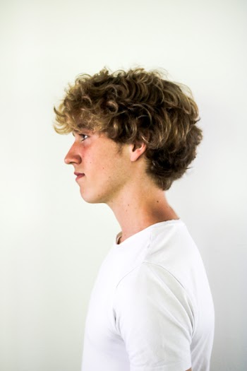 Photo of Man in White T-shirt Facing Sideways