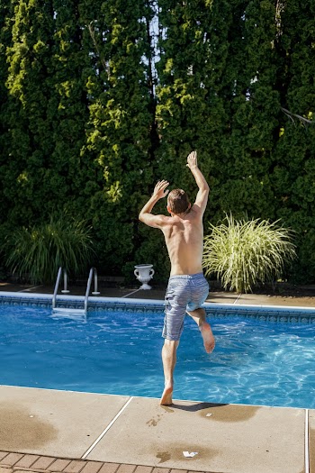 Photo Of Man Jumping In The Swimming Pool