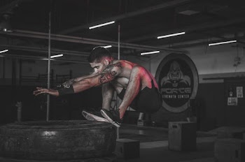 Photo of Man Jumping on Tires