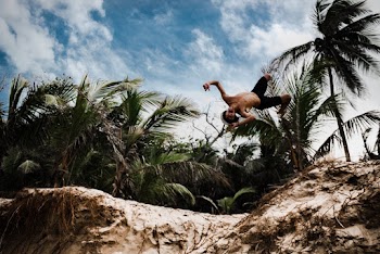 Photo of Man Jumping Over Cliff