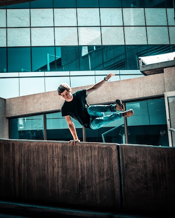 Photo Of Man Jumping Over The Wall