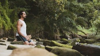 Photo Of Man Kneeling Near Rocks