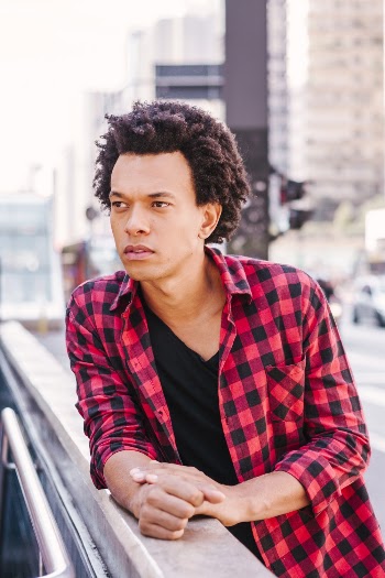 Photo Of Man Leaning On Concrete Surface