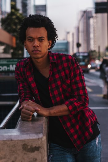 Photo Of Man Leaning On Concrete Surface