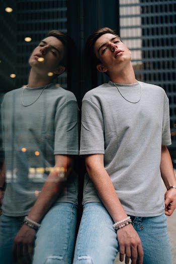 Photo Of Man Leaning On Glass