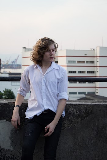 Photo Of Man Leaning On Handrails