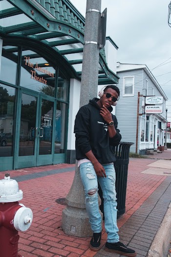 Photo Of Man Leaning On Post