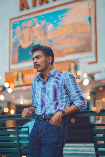 Photo of Man Leaning on Steel Bench