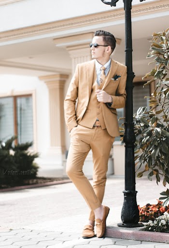 Photo of Man Leaning on Street Light