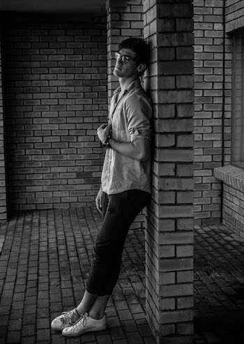 Photo of Man Leaning on Wall