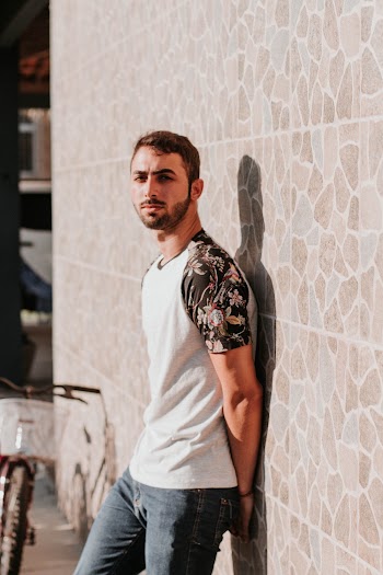 Photo of Man Leaning on Wall