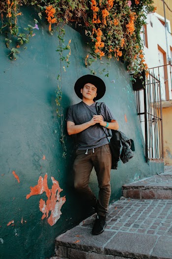Photo of Man Leaning on Wall