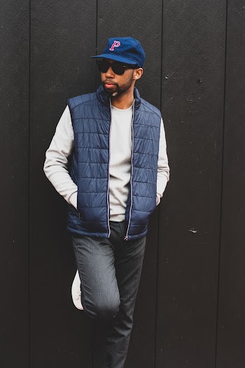 Photo of Man Leaning on Wall