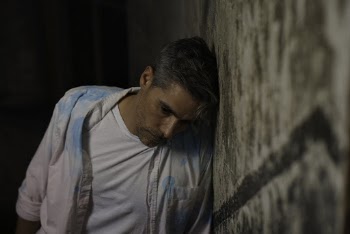 Photo of Man Leaning on Wall