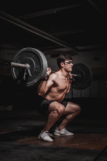 Photo of Man Lifting Barbell