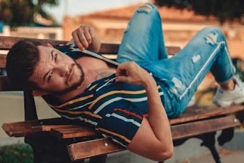 Photo Of Man Lying On Park Bench
