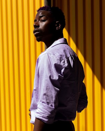 Photo Of Man Near Yellow Wall