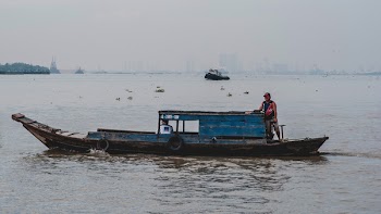 Photo of Man on Wooden Boat