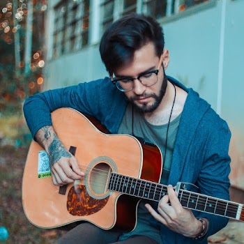 Photo of Man Playing Acoustic Guitar