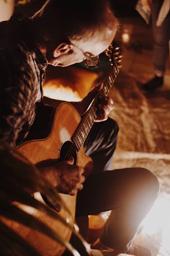 Photo of Man Playing Guitar
