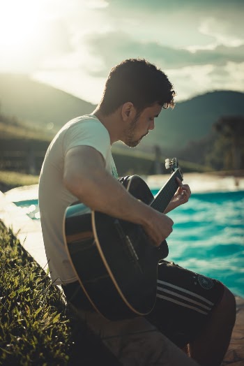 Photo Of Man Playing Guitar