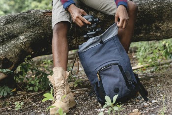 Photo of Man Putting Binoculars in a Backpack