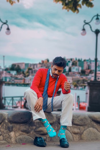 Photo of Man Putting on Shoes While Sitted