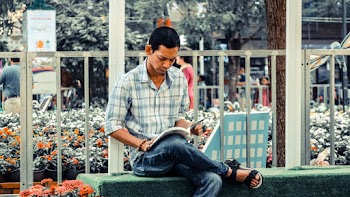 Photo of Man Reading Magazine