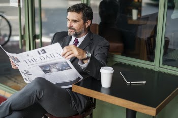 Photo of Man Reading Newspaper