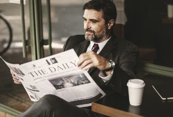 Photo of Man Reading Newspaper